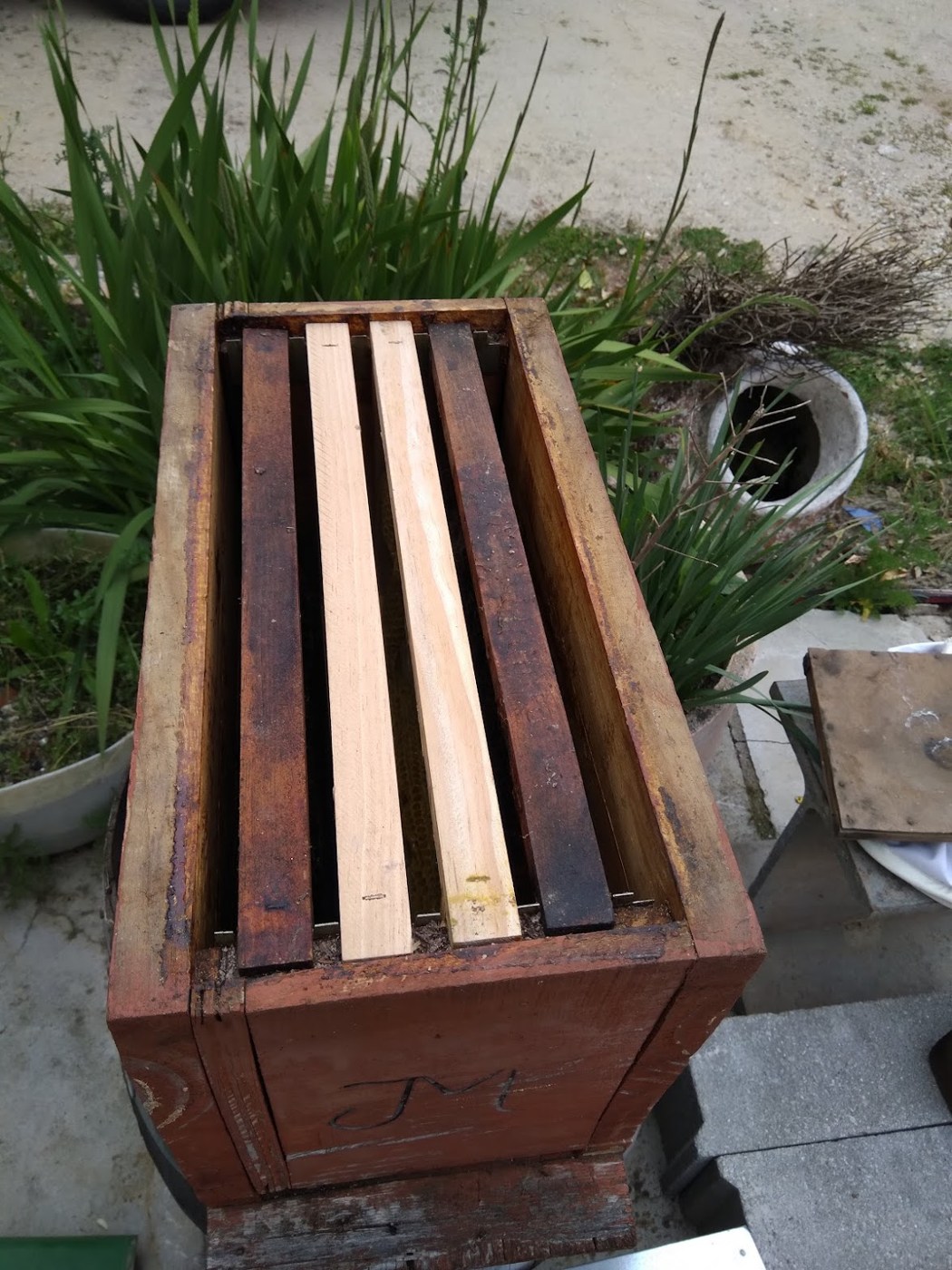 Dark wooden four-frame box used for catching swarms