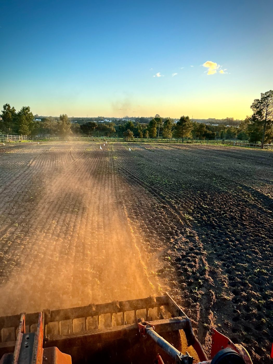 Farm field being worked before the autumn rain